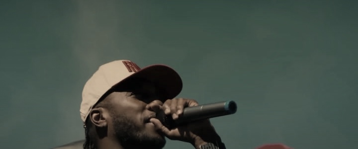 Lecrae on stage with a microphone